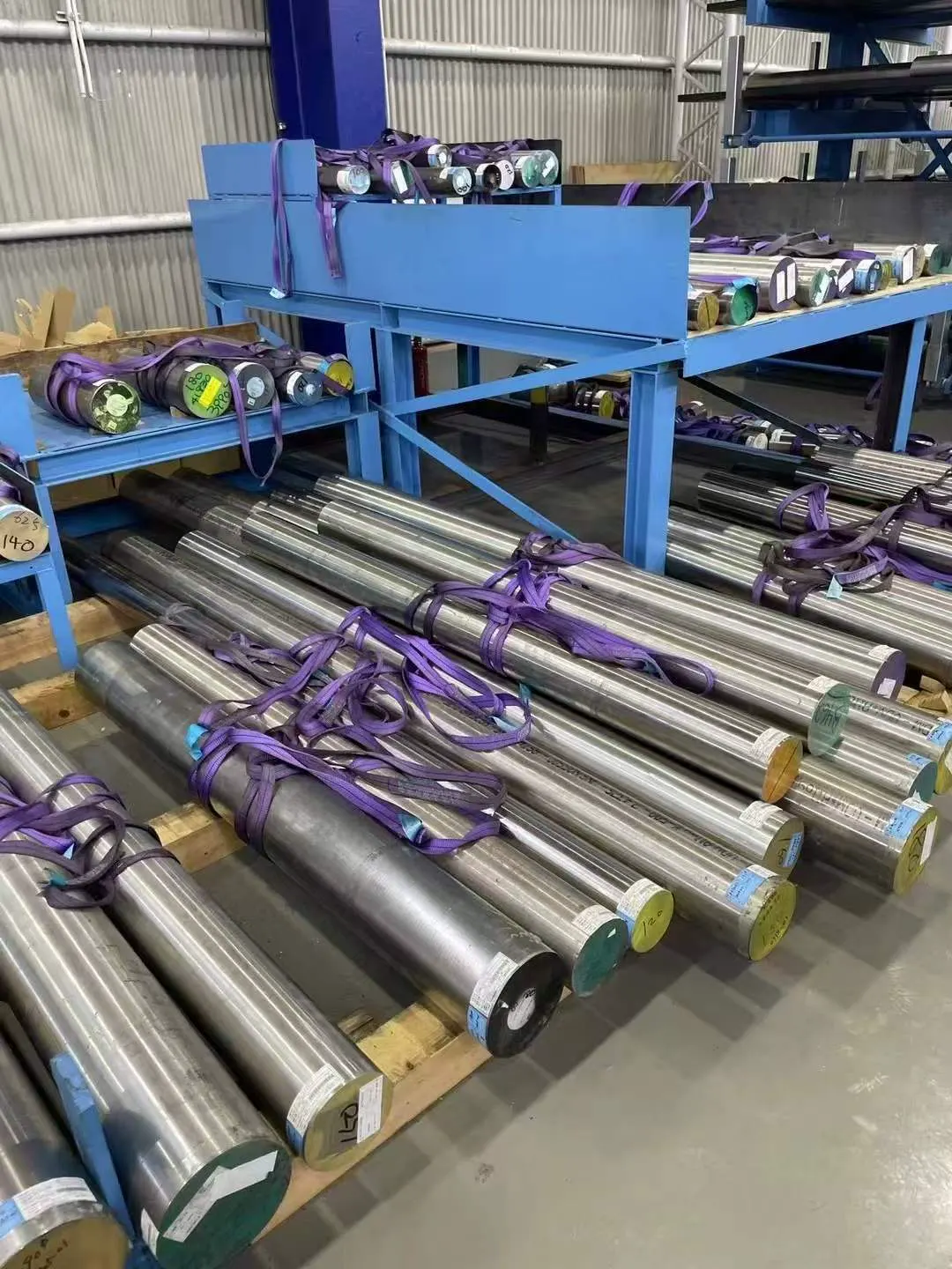 Large diameter nickel alloy round bars on wooden supports
